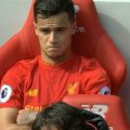 Coutinho relaxes on the bench after helping Liverpool beat Everton
